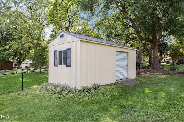 view of outbuilding featuring a lawn