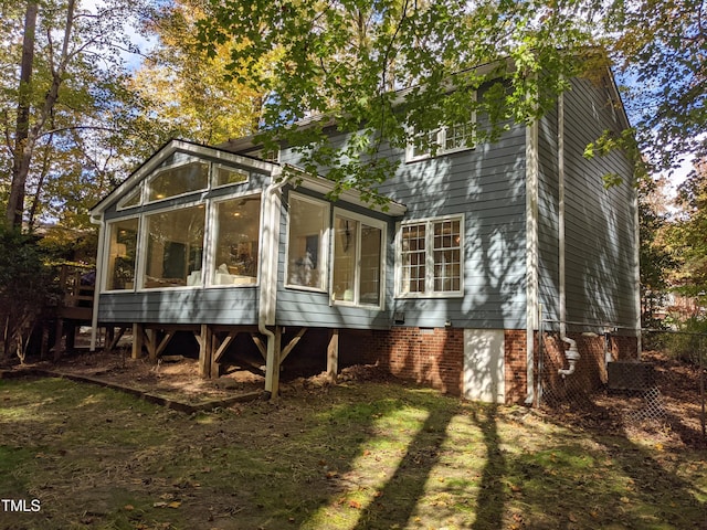 rear view of property with a sunroom