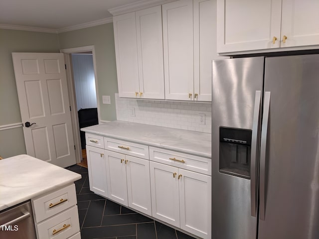 kitchen with backsplash, stainless steel appliances, ornamental molding, white cabinets, and dark tile patterned flooring