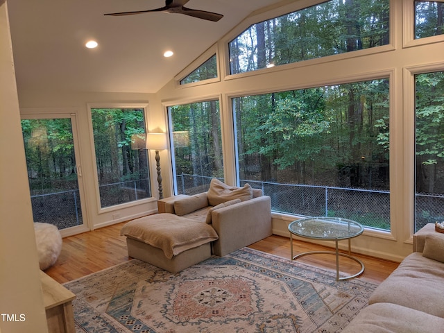 sunroom / solarium featuring lofted ceiling and ceiling fan