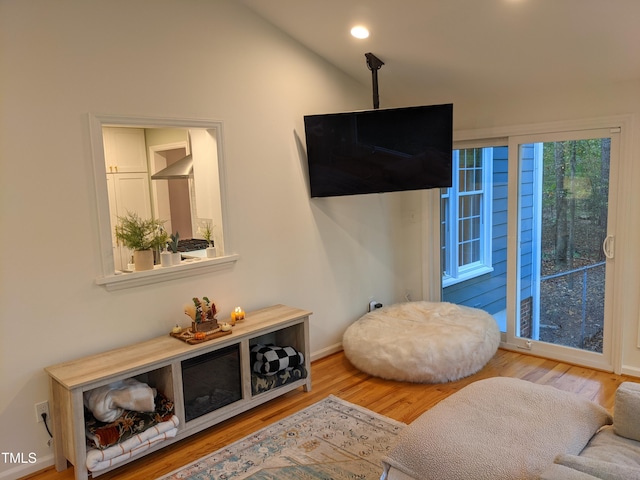 sitting room featuring hardwood / wood-style flooring and lofted ceiling