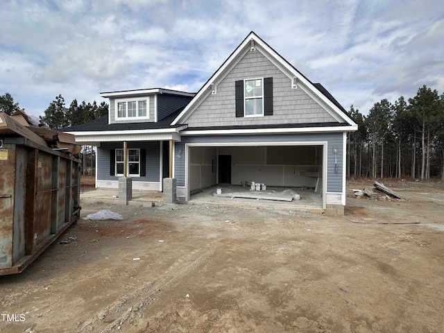 view of front of house featuring a garage and a porch