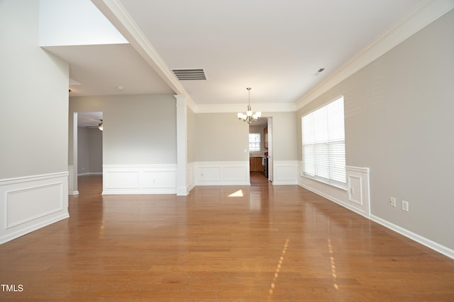 unfurnished room with ceiling fan with notable chandelier, ornamental molding, and hardwood / wood-style floors