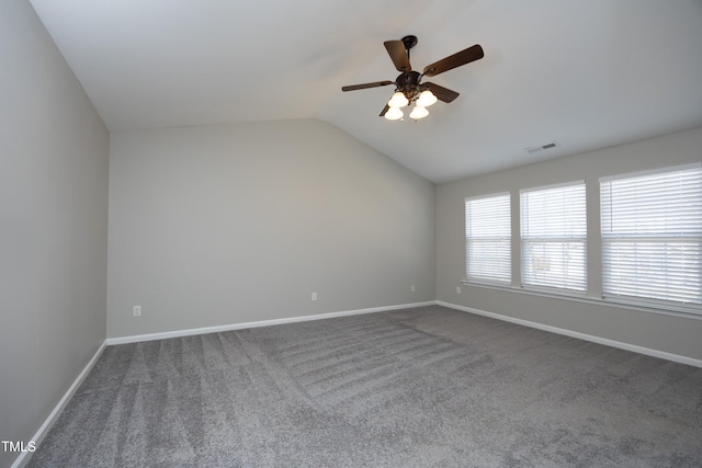 spare room with ceiling fan, lofted ceiling, and carpet floors