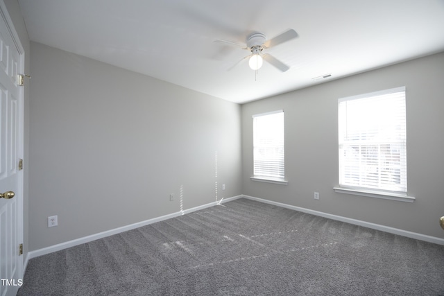 unfurnished room with ceiling fan and carpet