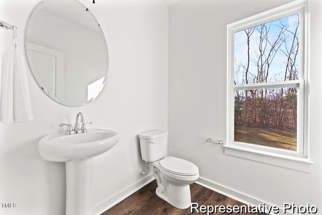 bathroom featuring sink, hardwood / wood-style flooring, a wealth of natural light, and toilet