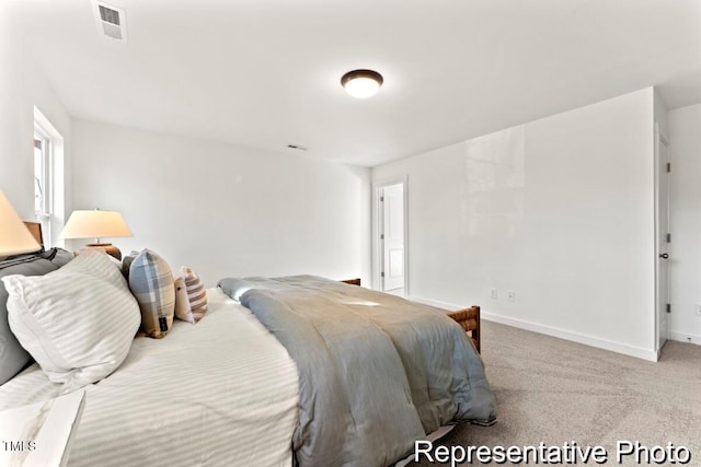 bedroom featuring light carpet