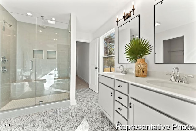 bathroom with an enclosed shower, vanity, and tile patterned flooring