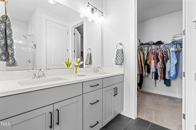 bathroom featuring tile patterned flooring, vanity, and walk in shower