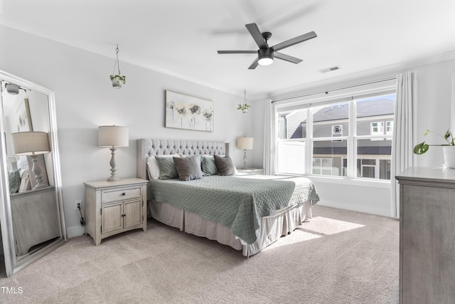 bedroom with light colored carpet and ceiling fan