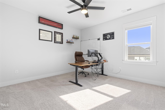 carpeted office featuring ceiling fan