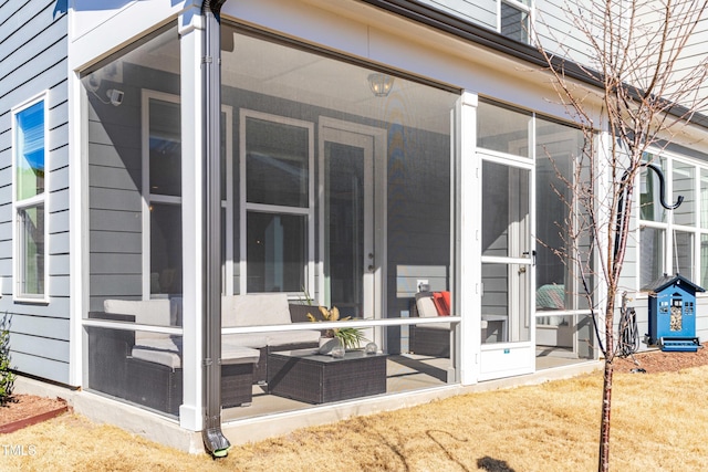 view of home's exterior with a sunroom