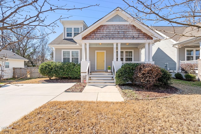 view of front of property with a porch and roof with shingles