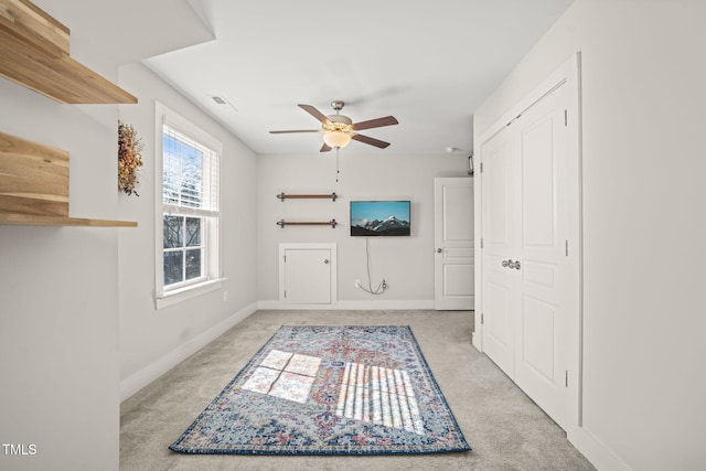 interior space with light carpet, visible vents, and baseboards