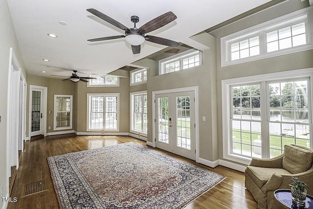 interior space with french doors, ceiling fan, and dark hardwood / wood-style flooring