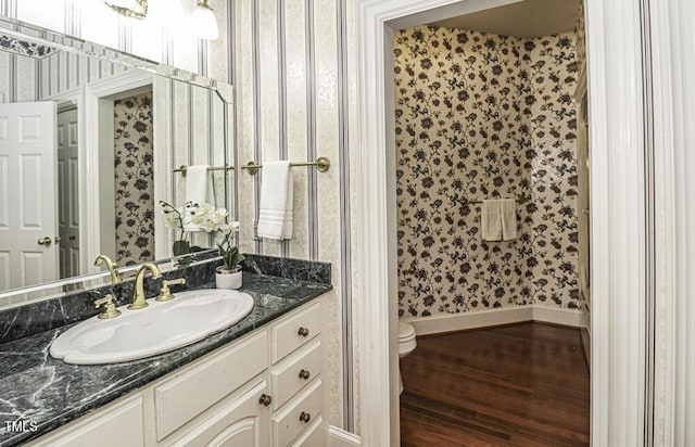 bathroom with vanity, hardwood / wood-style floors, and toilet