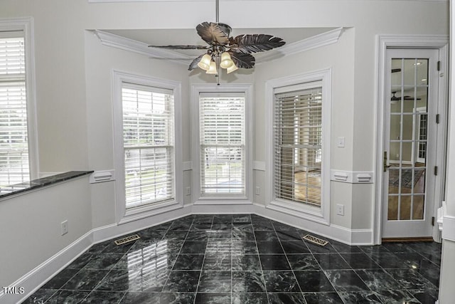 unfurnished dining area featuring ceiling fan and ornamental molding