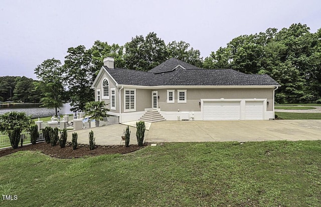 view of front facade with a garage and a front lawn