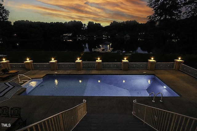 view of pool at dusk