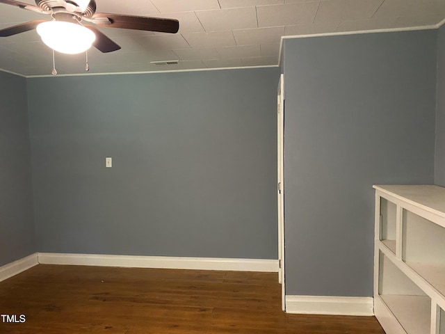 empty room with ceiling fan and dark hardwood / wood-style floors