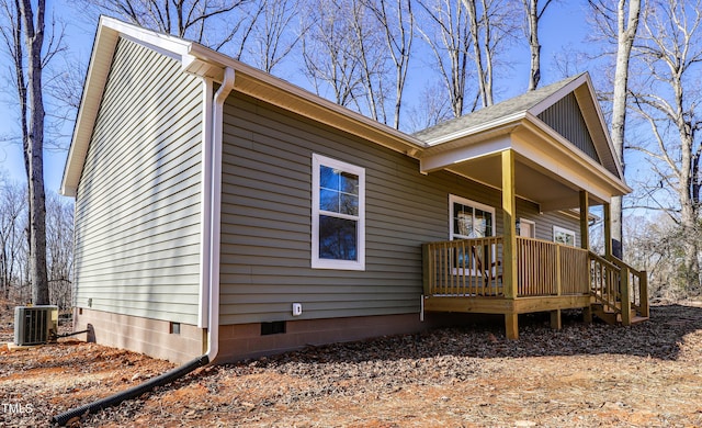 view of side of home featuring central AC unit and covered porch