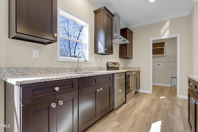 kitchen featuring light wood-type flooring, stainless steel appliances, sink, ornamental molding, and dark brown cabinets