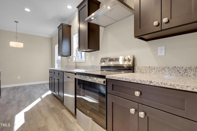 kitchen with wall chimney exhaust hood, dark brown cabinetry, sink, ornamental molding, and stainless steel appliances