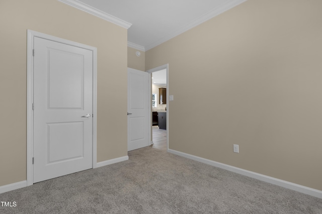 unfurnished bedroom featuring ornamental molding and light colored carpet