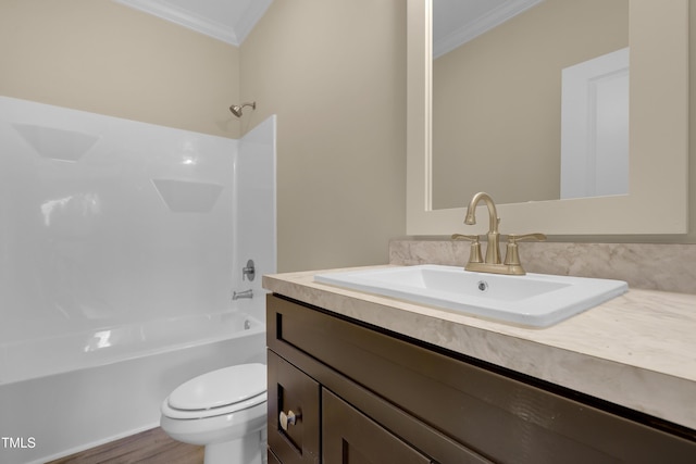 full bathroom featuring hardwood / wood-style flooring, ornamental molding, vanity, toilet, and bathing tub / shower combination