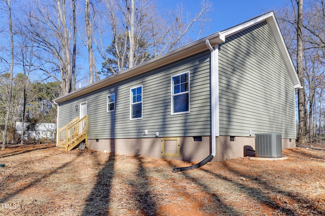 view of side of home with central AC