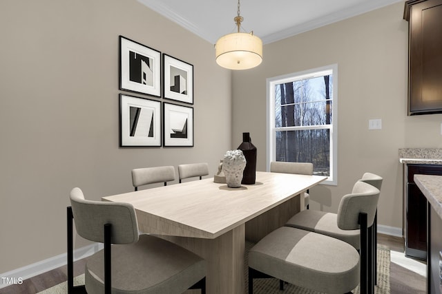 dining room featuring dark hardwood / wood-style flooring and ornamental molding