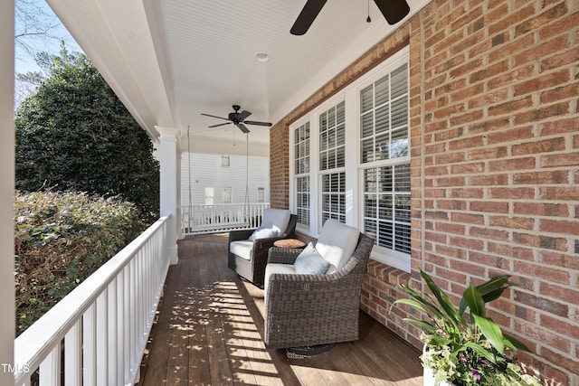 deck featuring covered porch and ceiling fan