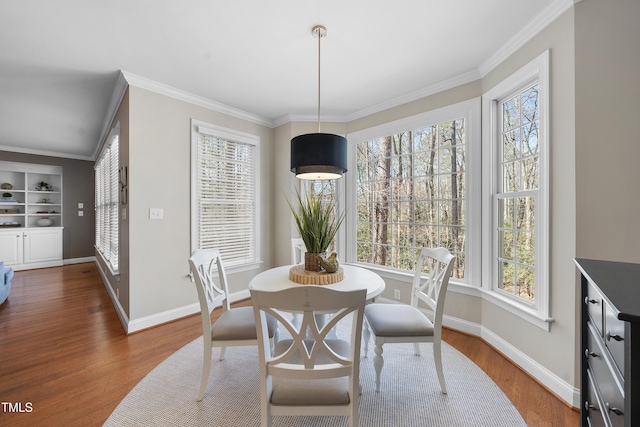 dining space with plenty of natural light, wood finished floors, and baseboards