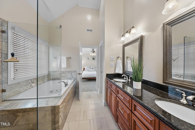 full bathroom featuring tiled bath, visible vents, a sink, and double vanity