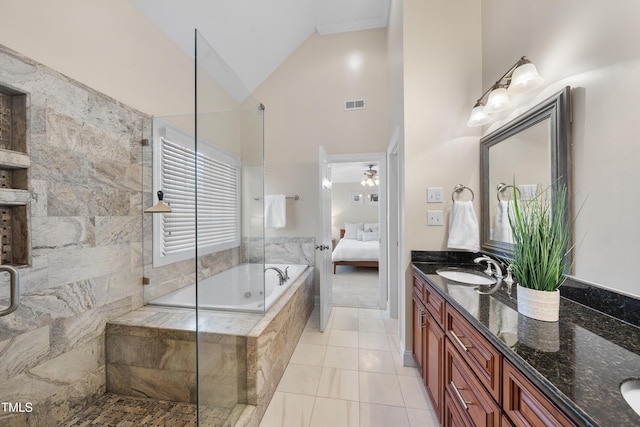 ensuite bathroom with tiled tub, visible vents, a tile shower, and double vanity