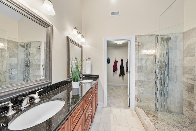 bathroom with a stall shower, visible vents, a sink, and double vanity