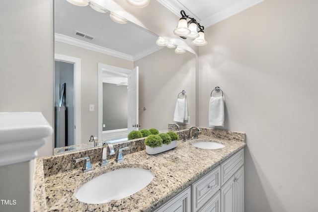 full bath featuring crown molding, visible vents, a sink, and double vanity