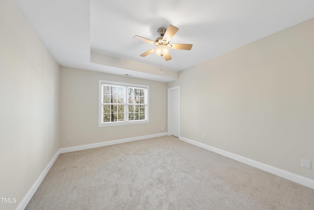 spare room with ceiling fan, baseboards, and carpet flooring