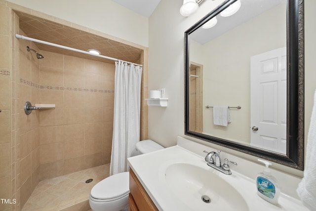 bathroom featuring tiled shower, vanity, and toilet