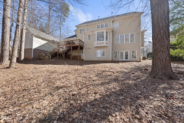 rear view of house with stairway, a wooden deck, and central AC unit