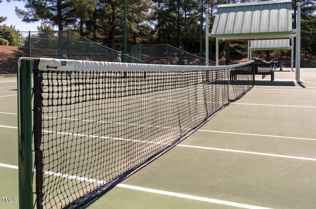 view of tennis court with fence