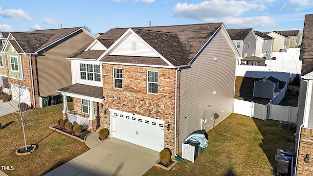 view of front of house featuring a garage, a front lawn, and central air condition unit