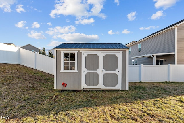 view of outdoor structure featuring a lawn