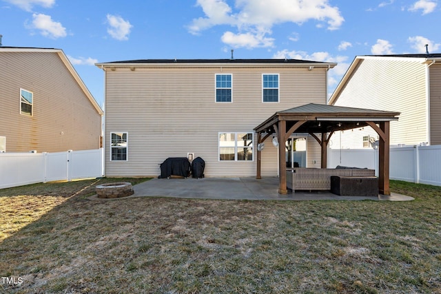 back of house featuring a gazebo, a patio area, an outdoor living space with a fire pit, and a lawn