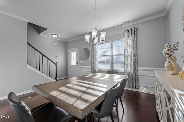 dining room featuring an inviting chandelier, crown molding, and dark hardwood / wood-style floors