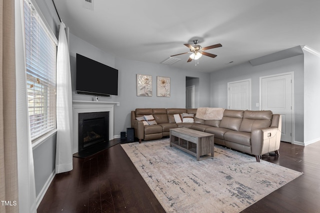 living room with ceiling fan and dark hardwood / wood-style floors