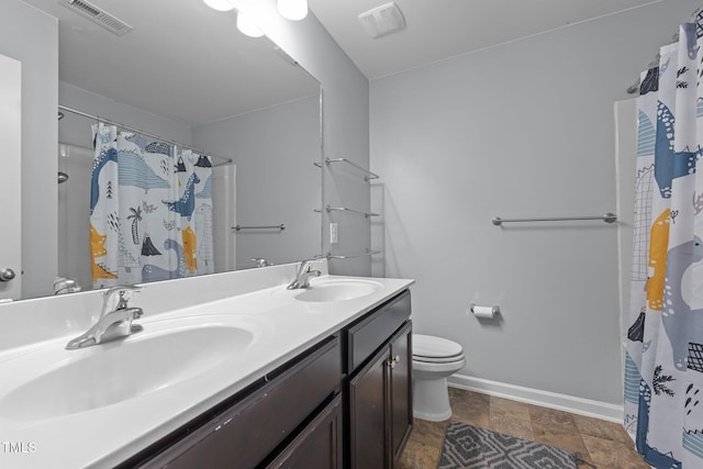 bathroom with vanity, toilet, and walk in shower