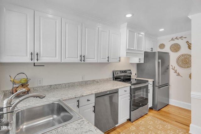 kitchen featuring sink, light hardwood / wood-style flooring, stainless steel appliances, light stone countertops, and white cabinets