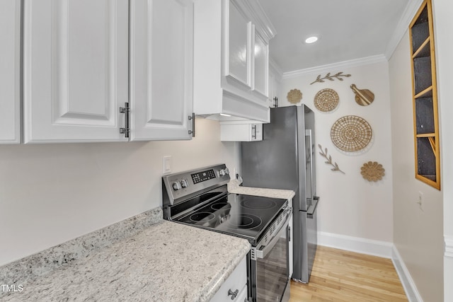 kitchen with crown molding, light stone countertops, light hardwood / wood-style floors, white cabinets, and stainless steel electric stove