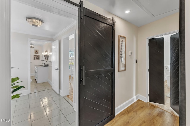 interior space featuring hardwood / wood-style flooring, crown molding, and sink